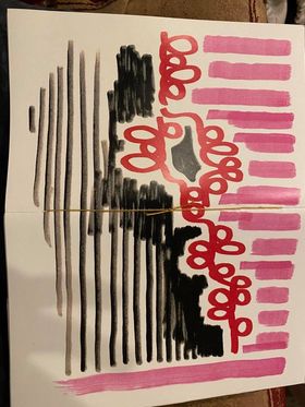The zine is spread open with the cover facing up. There are pink vertical lines along the top, red squiggles, and black horizontal lines along the bottom. There is a piece of string along the spine.