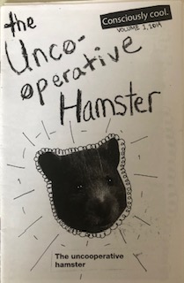 White cover, handwriting reads “the Unco-operative hamster”, there is a cut out inage of a hamster’s head.