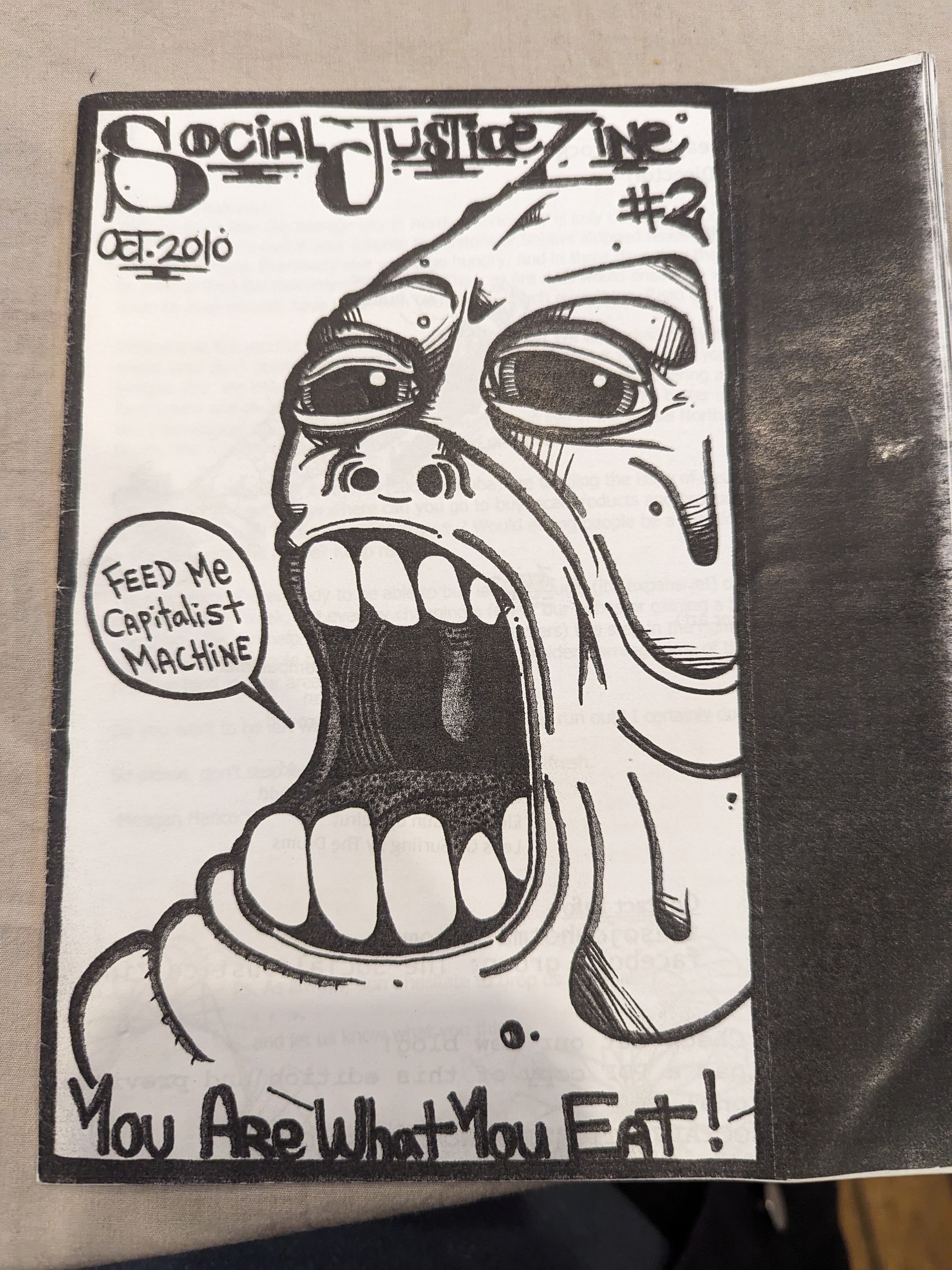 A very large face saying "feed me capitalist machine"