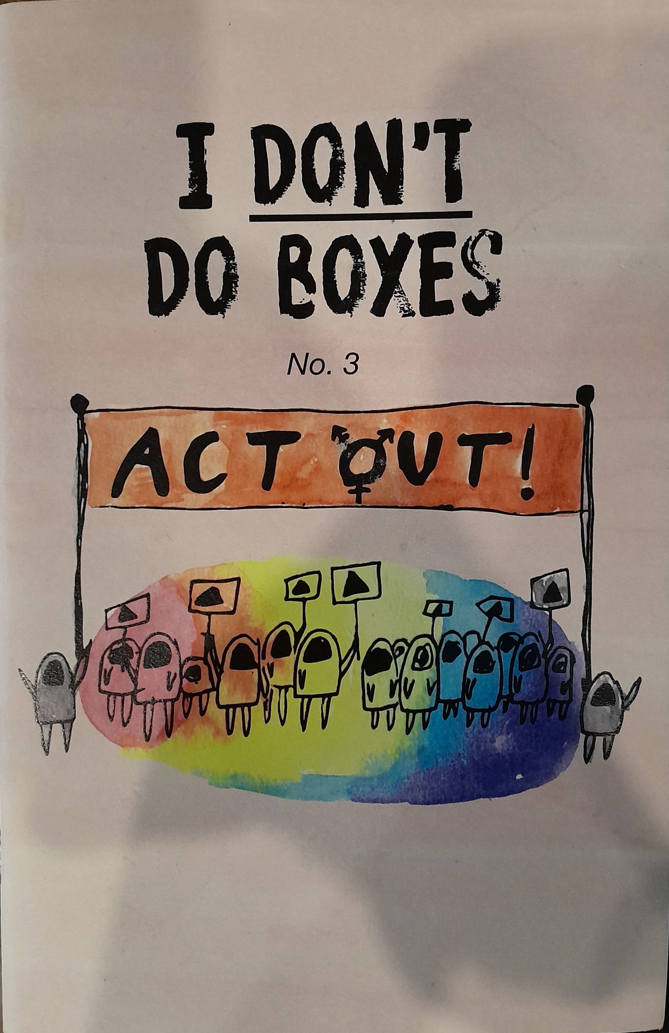 A minimalist, abstract ink and watercolour illustration of several people holding up protest signs and a large banner. The banner text depicts the name of the magazine, "Act Out", with the O replaced by the Transgender symbol. Most of the crowd, save for the two on the outside edges holding up the banner, are standing inside of a circular rainbow gradient.