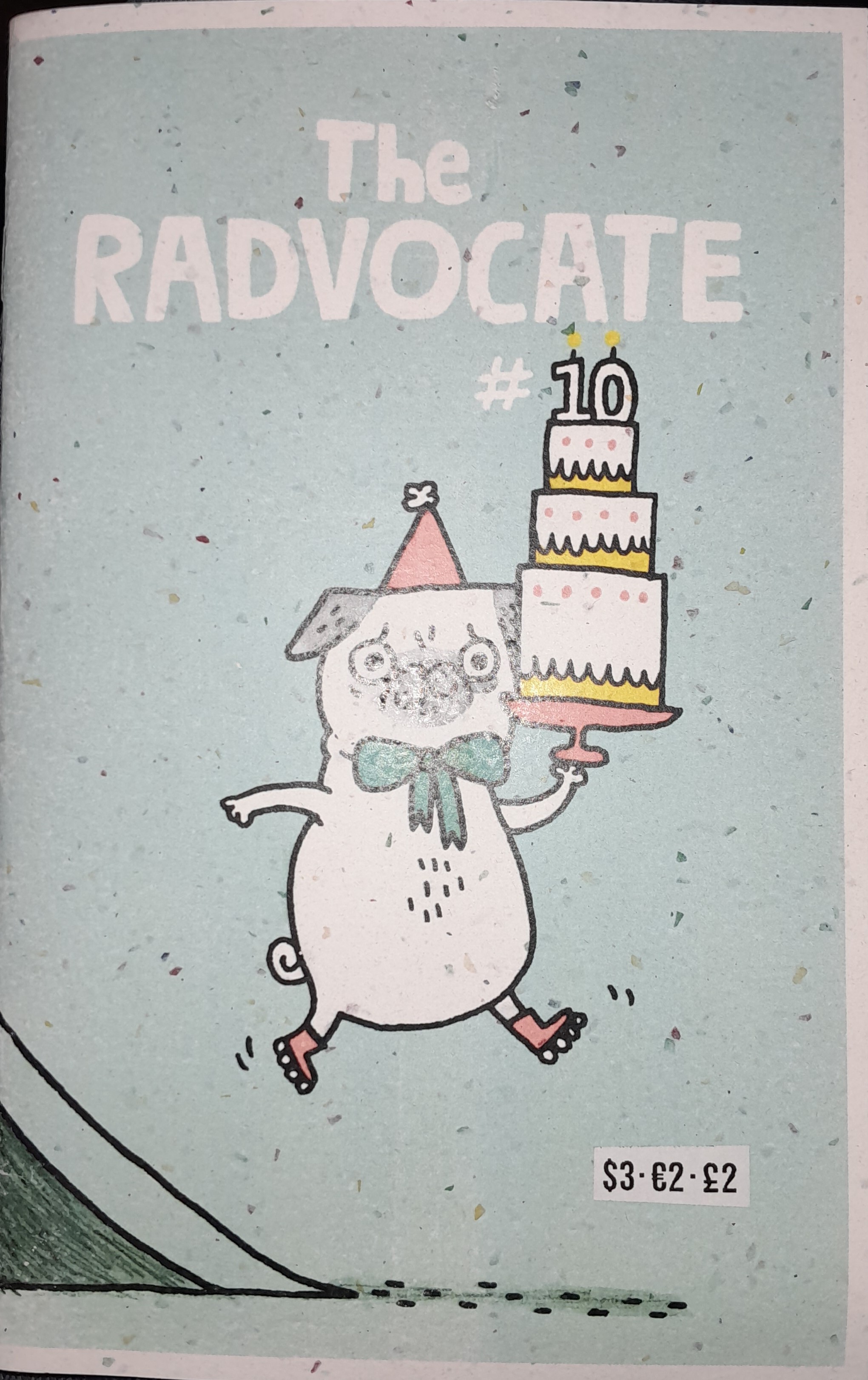 An illustration of a gray and white pug dog in a party hat, bow tie, and rollerblades carrying a serving tray with a three-tiered cake. Atop the cake are candles depicting the number 10, which is the issue number of this volume of the Radvocate Magazine. The cover has a blue background, and parrt of a ramp can be seen off to the left, with motion lines indicating that the dog is mid-hop. "The RADVOCATE", the title of the magazine, is set against the background in a white, hand-drawn font.