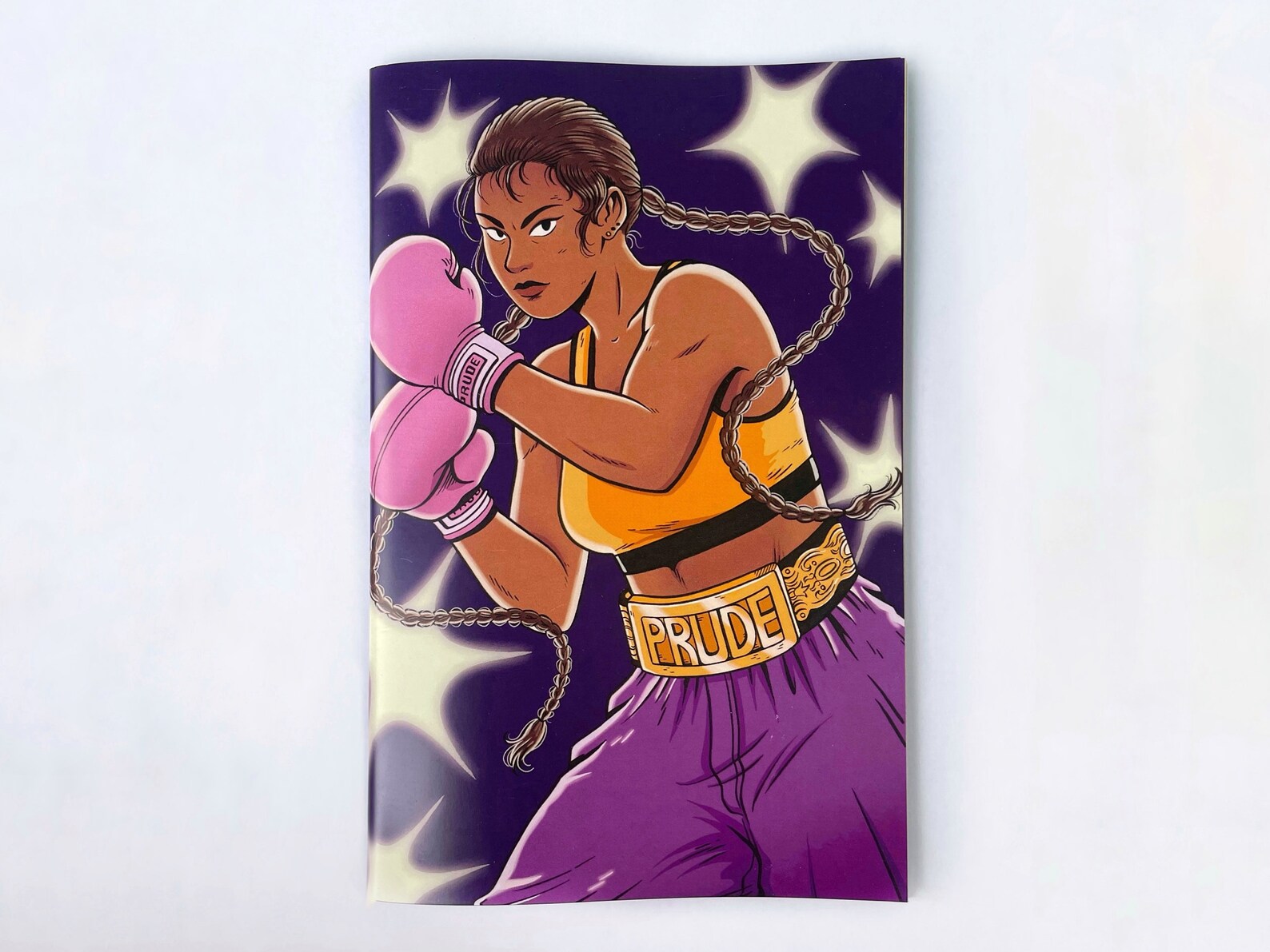 Cover of Prude zine #2, which shows a boxer wearing purple shorts and a gold belt that says "Prude."