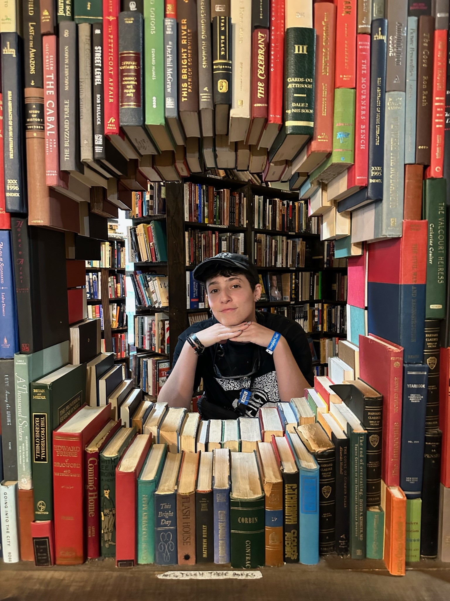Photo of Bellamy Jacobs' face inside a portal of books
